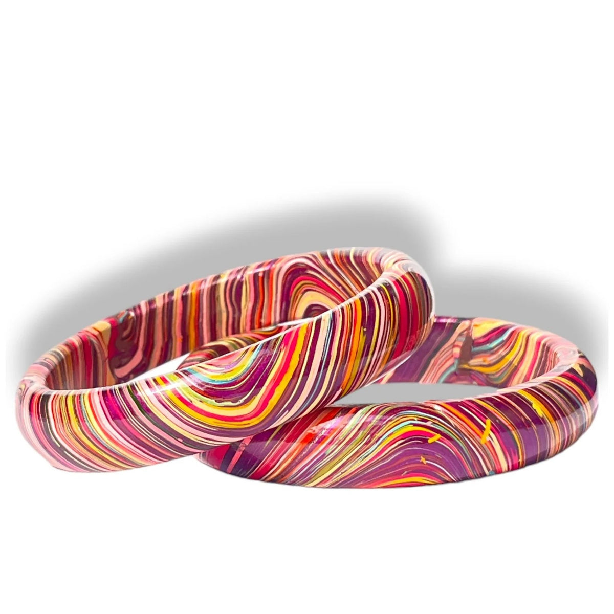 Two glossy bangles with a vibrant marbled swirl pattern of pink, purple, yellow, orange, and red on a white background.