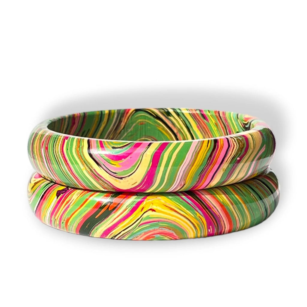 Two stacked bangles with a vibrant, multicolored swirl pattern of pink, green, yellow, orange, and black on a white background.