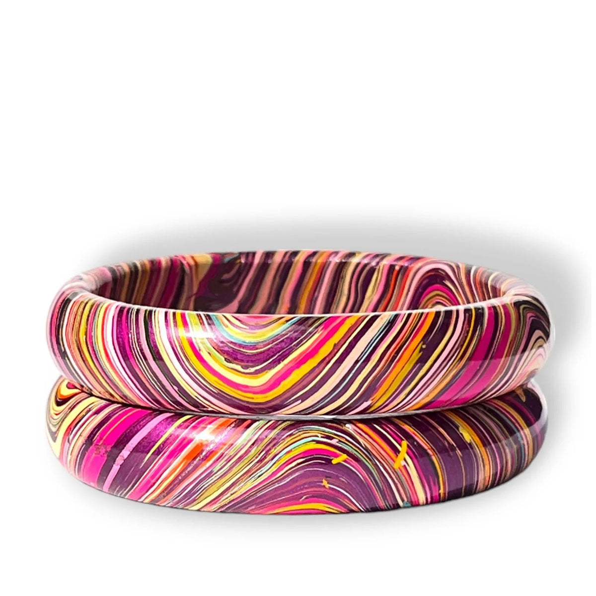 Two stacked bangles with a vibrant marbled swirl pattern of pink, purple, yellow, orange, and white on a white background.